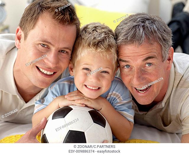 Portrait of smiling son, father and grandfather on floor