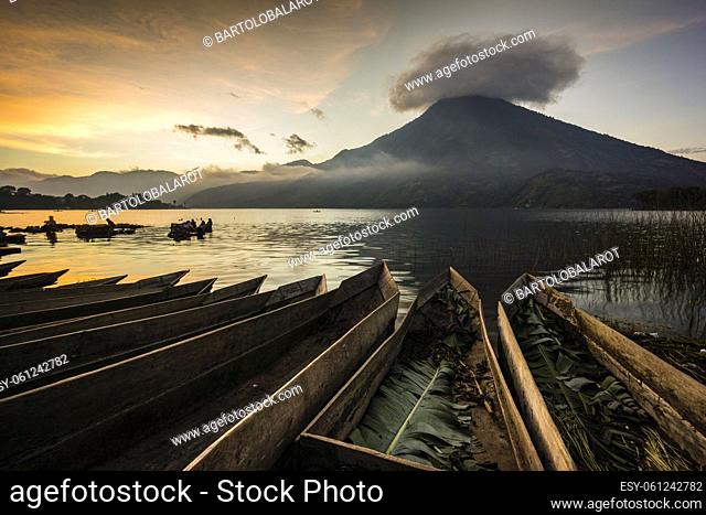 Canoes beached on Lake Atitlan in front of Volcan San Pedro, Santiago Atitlan, Sololá Department, Guatemala, Central America