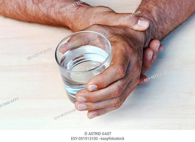 The hands of a man with Parkinson's disease tremble. Strongly trembling hands of an older man
