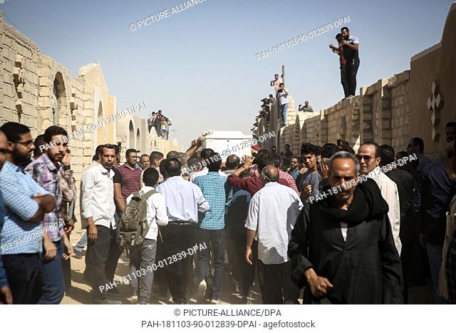 03 November 2018, Egypt, New Minya: People carry a coffin at the Coptic graves during the funeral of the victims who were killed during a gun attack on a bus...