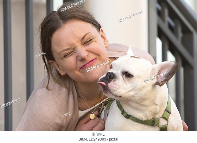 Portrait of Caucasian woman making a face with dog