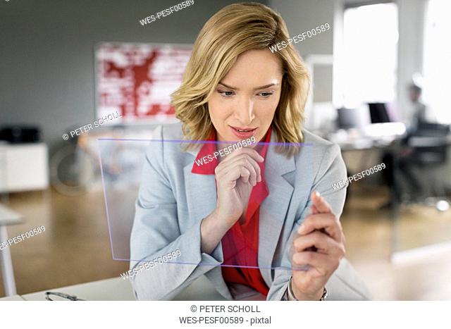 Businesswoman using futuristic portable device