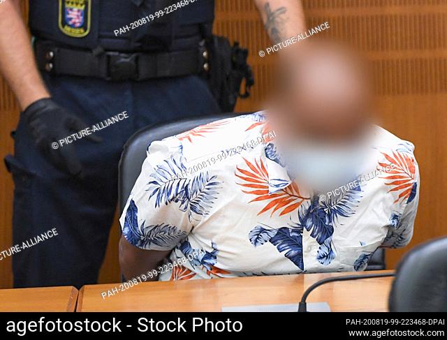 19 August 2020, Hessen, Frankfurt/Main: A judicial officer stands in the courtroom of the Frankfurt Regional Court at the start of the trial behind a...