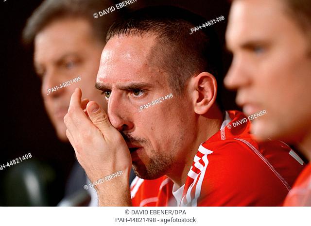 Bayern Munich's director of media and press relations Markus Hoerwick (L-R), goalkeeper Manuel Neuer and Franck Ribery speak during a press conference at the...