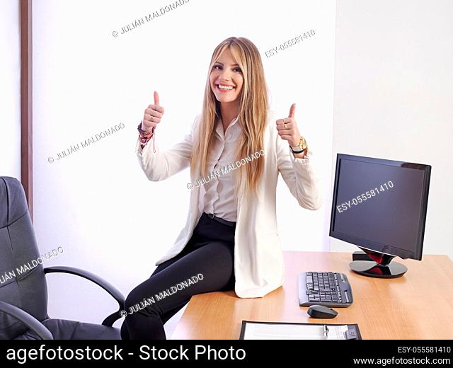 Young business woman smiling and with positive attitude