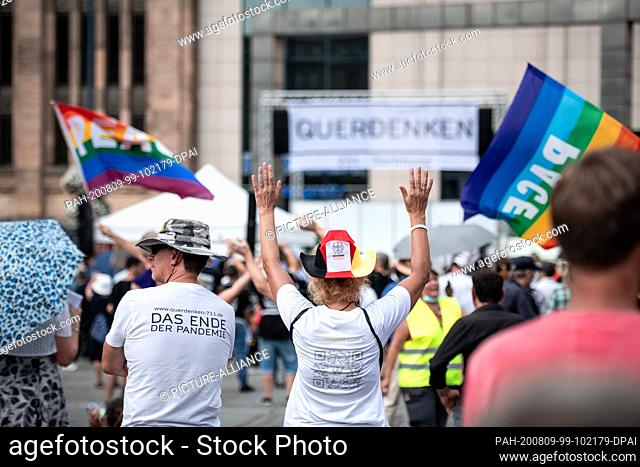 09 August 2020, North Rhine-Westphalia, Dortmund: A female participant with a Germany hat and constitution is standing in the crowd
