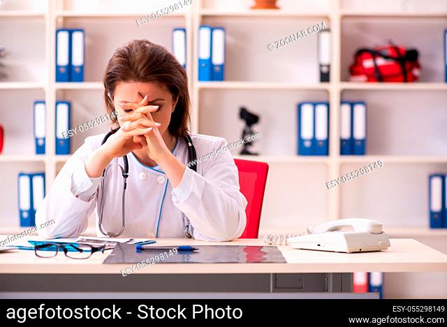 Aged female doctor working in the clinic