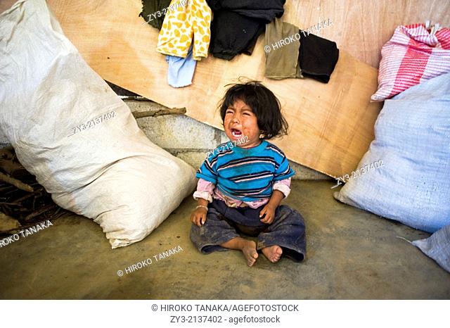 A Guatemala indigenous child in the poorly built house in Aqua Escondida in Solola department in Guatemala