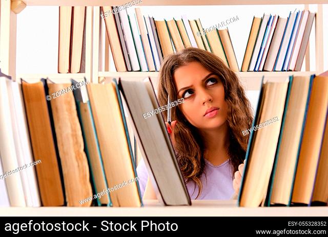 The young female student preparing for exams at library
