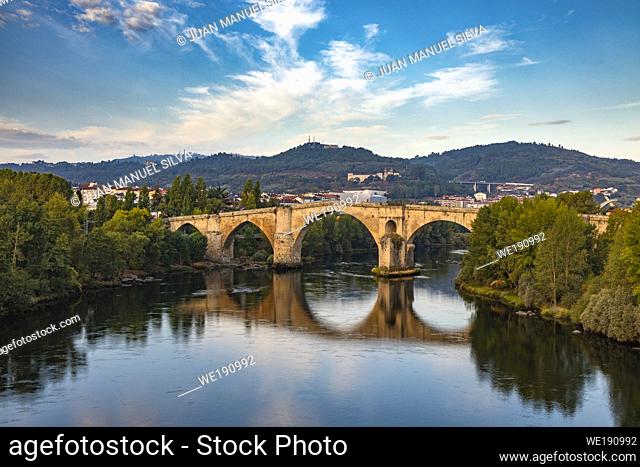 Roman bridge in Ourense (Galicia, Spain), over river Miño and city scape in the background