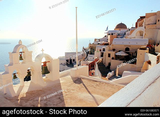 Oia town on Santorini island, Greece. Traditional houses and sea in sunset time