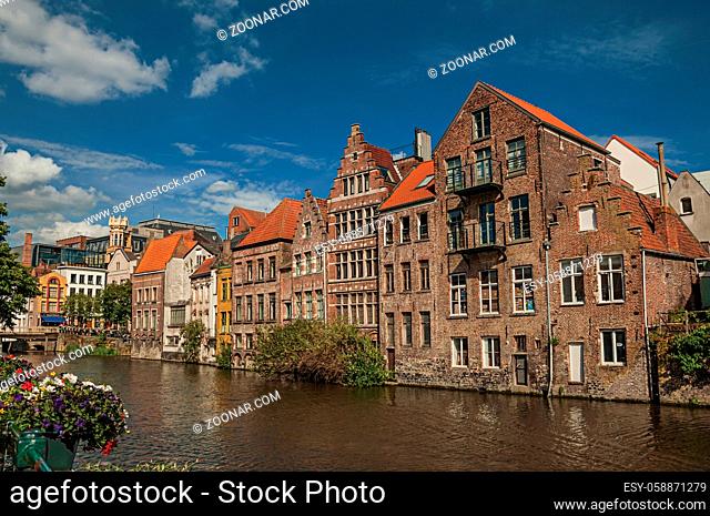Old buildings in front of the canal with blue sky in the City Center of Ghent. In addition to intense cultural life, the city is full of Gothic and Flemish...