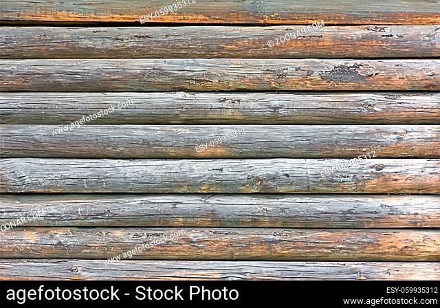 Fragment of the old wooden walls of pine logs. Texture of the old log walls