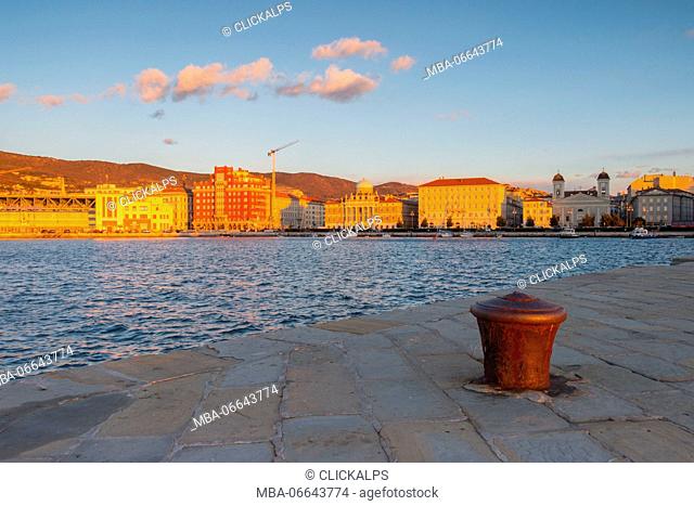 The neoclassic structures seen from Audace molo in Trieste at sunset. Trieste city, Trieste Province, Friuli Venezia Giulia district, Italy, Europe