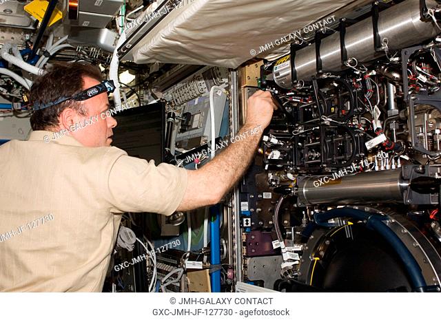 NASA astronaut Ron Garan, Expedition 28 flight engineer, works with the Combustion Integrated Rack (CIR) Fluids and Combustion Facility (FCF) in the Destiny...
