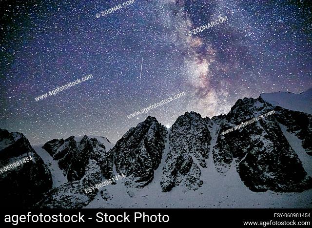 Milky Way and snowy mountains in Altai at night