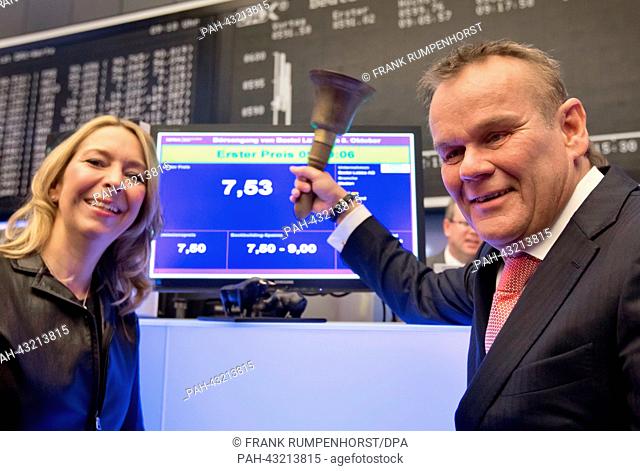 Publisher Stefan Luebbe stands next to his wife Birgit as he rings the bell shortly after the publishing house Bastei Luebbe went public at the stock exchange...