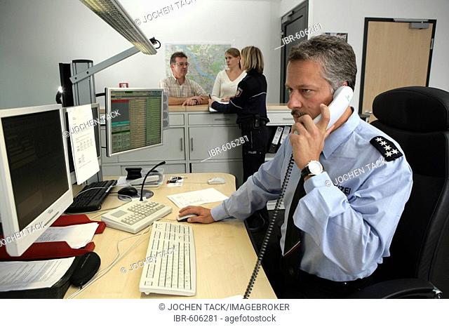 Police officer making a phone call at the office, new blue police uniforms worn by 1400 male and female North Rhine-Westphalian police officers, Duesseldorf