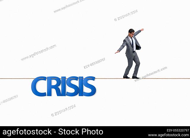 Crisis concept with businessman walking on tight rope