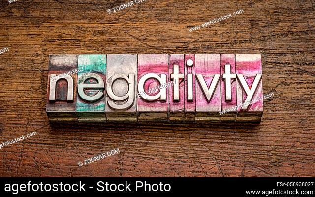 negativity word abstract in gritty vintage letterpress metal type against rustic, weathered wood, work, stress and lifestyle concept