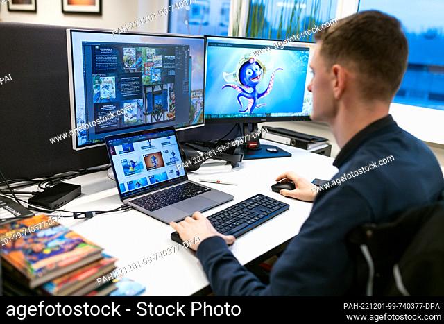 ILLUSTRATION - 30 November 2022, Baden-Wuerttemberg, Rust: An employee of ""Macknext"" sits at a workstation prepared for the photo during a press event