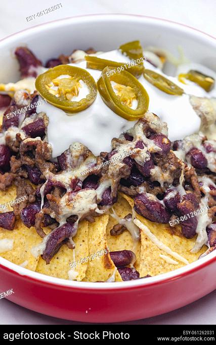 nachos baked with mince beef meat, cheese and red beans