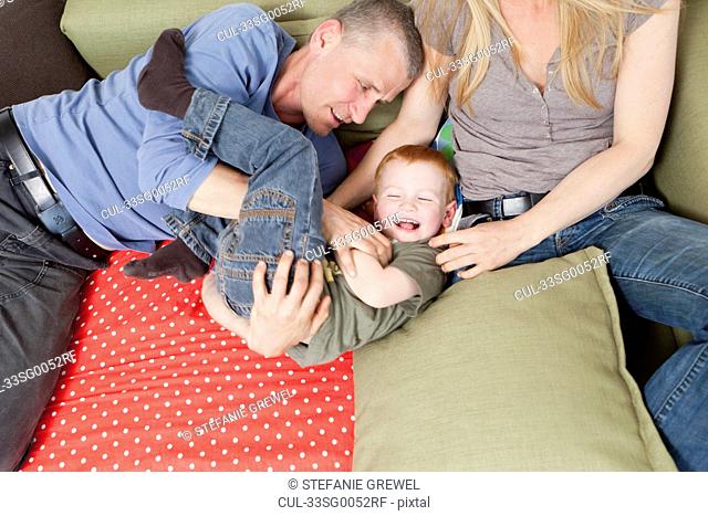 Family playing together on sofa