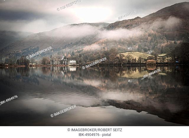 Hilly landscape reflected in water surface at Fog Mood, Rydal Water, Ambleside, Lake District National Park, Central England, United Kingdom, Europe