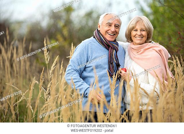 Portrait of happy senior couple having a walk