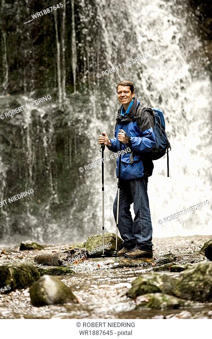 Man Standing In Front Of A Waterfall, Bavaria, Germany, Europe