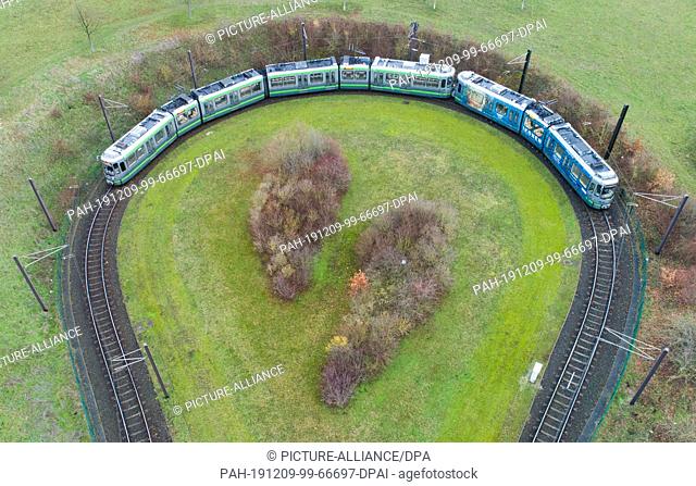 09 December 2019, Lower Saxony, Hanover: A tram line 6 of Ìstra Hannoversche Verkehrsbetriebe travels through a reversing loop (aerial photo with drone) at the...