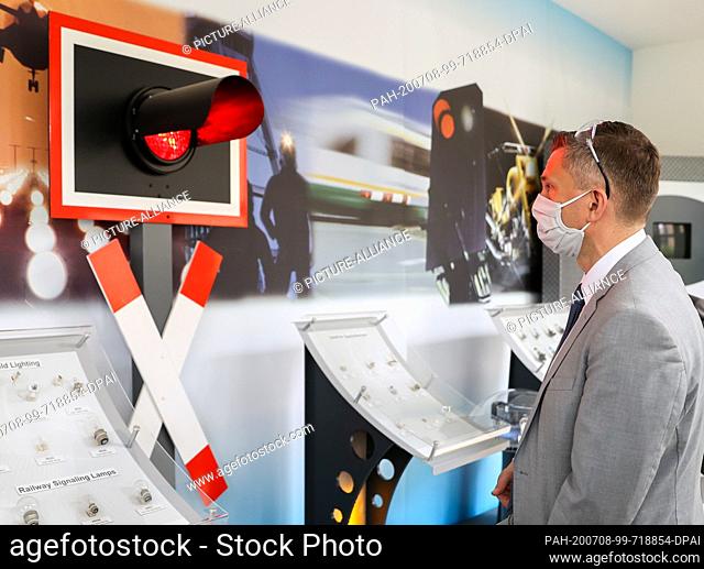 08 July 2020, Saxony, Plauen: Martin Dulig (SPD), Minister of Economics of Saxony, stands in front of signal lights in the Vosla GmbH The manufacturer of...