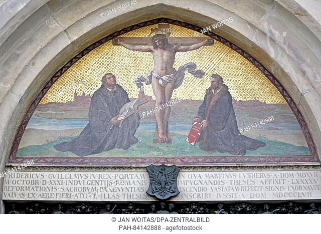 A picture with Jesus on the cross and Martin Luther (L) and Philipp Melanchthon kneeling below can be seen above the door with Luther's 95 theses at the...