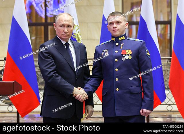 RUSSIA, MOSCOW - DECEMBER 19, 2023: Russia's President Vladimir Putin (L) and Hero of Russia, Junior Sergeant Vyacheslav Matskevich shake hands during a...