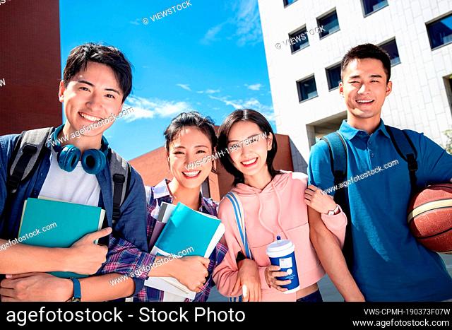 Two couples holding together for college students on campus