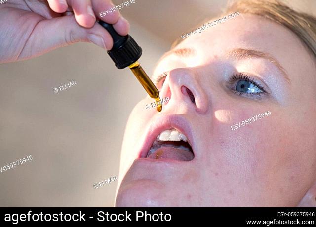 woman taking homeopathic drugs, alternative medicine, pseudoscientific healing and treatment method