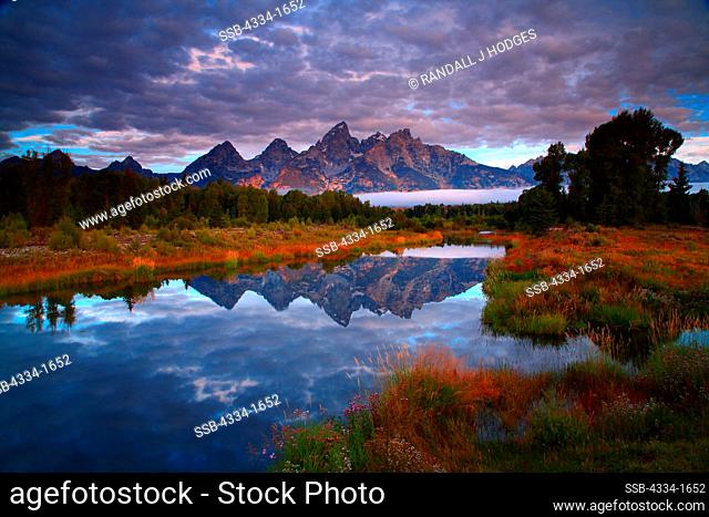 USA, Wyoming, Sunrise with Grand Tetons reflected in Beaver Ponds along Snake River in Grand Teton National Park