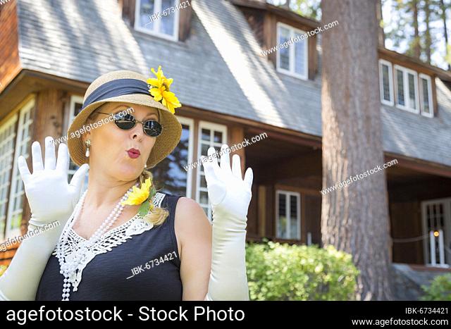 Attractive young woman in twenties outfit near antique house
