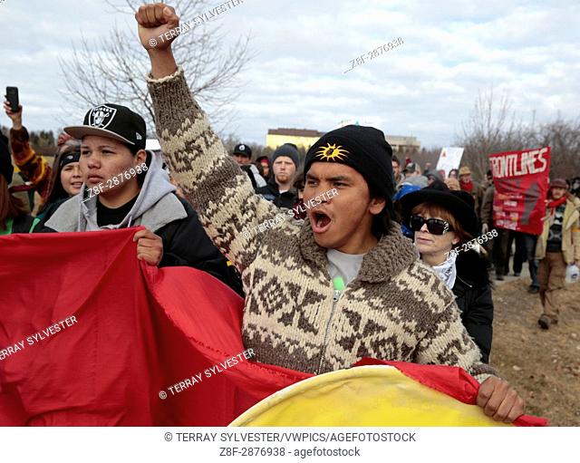 Roy Murphy of the Muckleshoot Tribe in Washington State raises a fist during a march against the Dakota Access oil pipeline on the North Dakota capitol grounds...