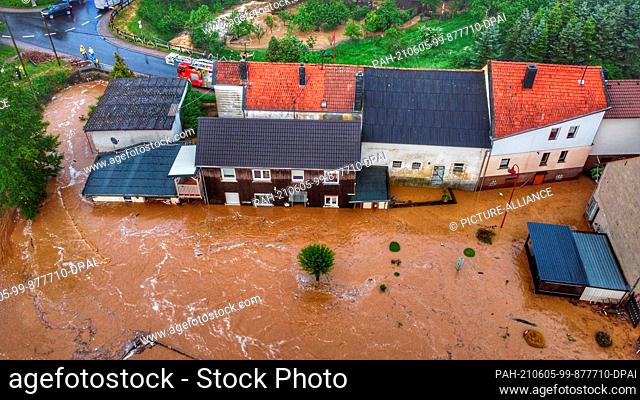05 June 2021, Rhineland-Palatinate, Gebroth: Houses in Gebroth are surrounded by floodwater after the storm. Thunderstorms have given emergency services in...