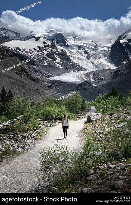 Woman hiking on the Morteratsch Glacier in the Engadin in the Swiss Alps in summer