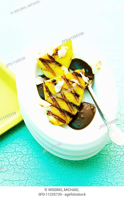Grilled mango with coconut served with chocolate sauce