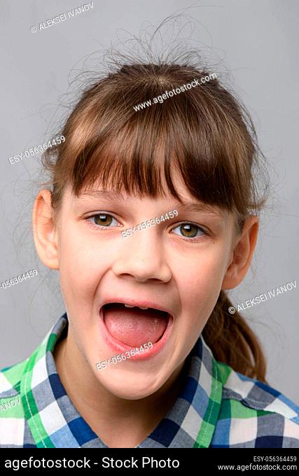 Portrait of a happy ten year old girl with wide mouth, European appearance, close-up