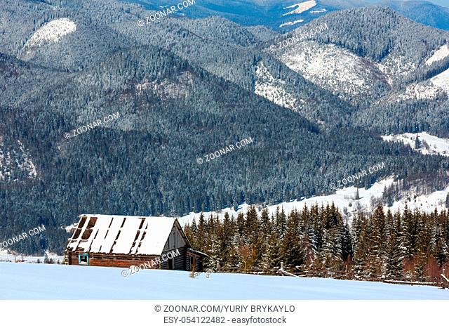 Picturesque winter mountain view from Skupova mountain slope, Ukraine, Carpathian. Old ruined wooden shed
