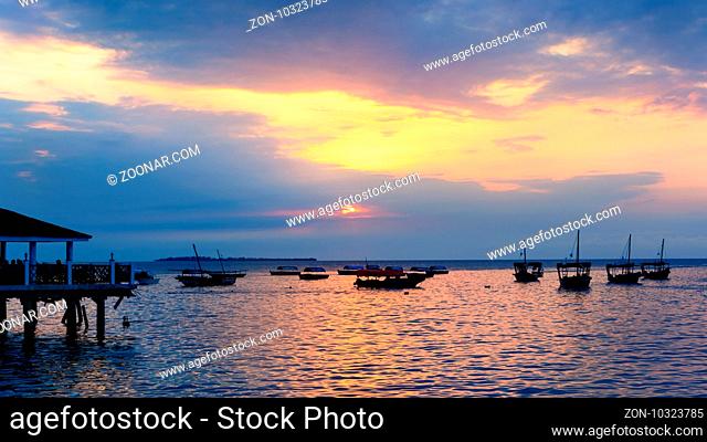 Typical boats docked in the port of Stone Town , Zanzibar, Tanzania republic, at sunset