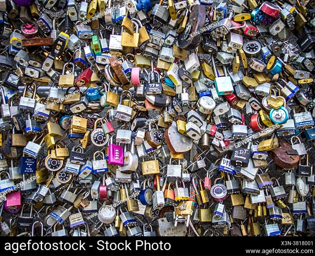 Full frame of padlocks attached to chain link fence, San Antonio, TX