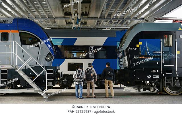 Visitors look at exhibited trains ahead of the railyway technology fair Innotrans in Berlin, Germany, 22 September 2014. More than 2