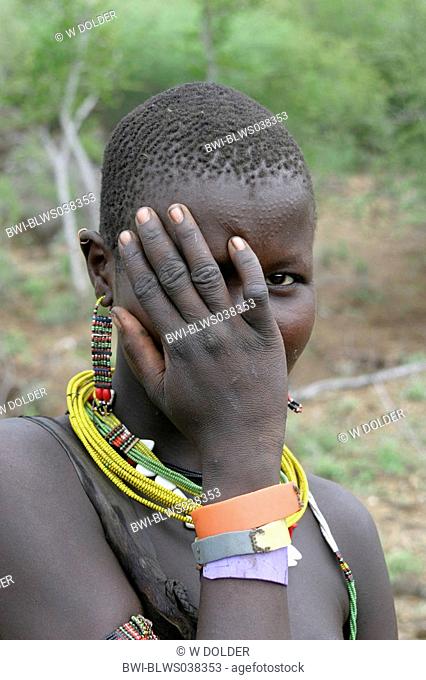 young Toposa woman, hand covering her face, Sudan