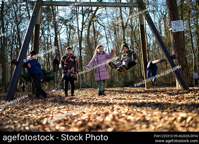 10 March 2022, Lower Saxony, Lüneburg: Orphans from Ukraine swinging on a playground. 31 Ukrainian orphans have arrived safely in Lüneburg and are staying in...