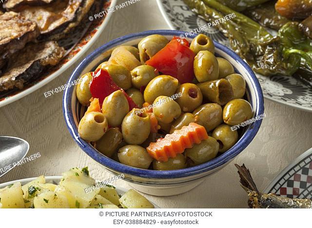 Bowl with traditional Moroccan pickled olives as a side dish close up